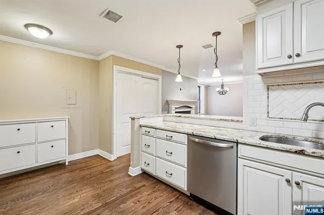 a kitchen with granite countertop white cabinets and white appliances