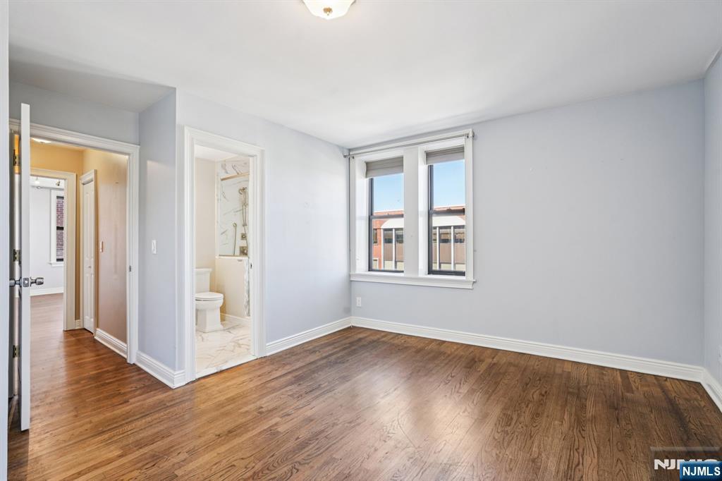 109 Grand Avenue, Unit 4A Englewood, NJ 07631 - Photo 31 of 39 an empty room with wooden floor and windows
