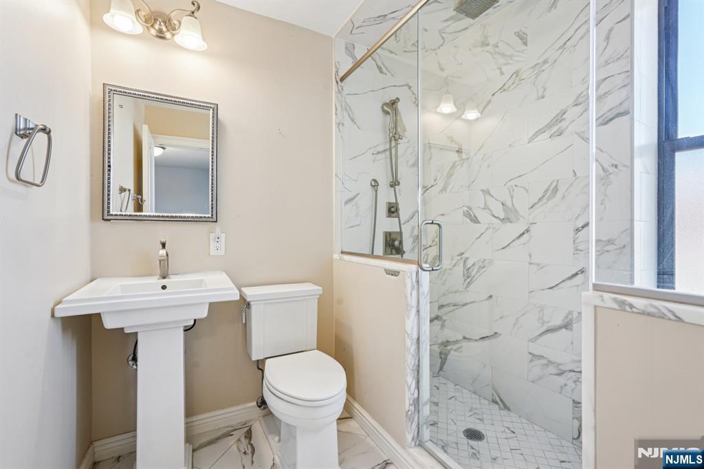 109 Grand Avenue, Unit 4A Englewood, NJ 07631 - Photo 37 of 39 a bathroom with a sink toilet and shower
