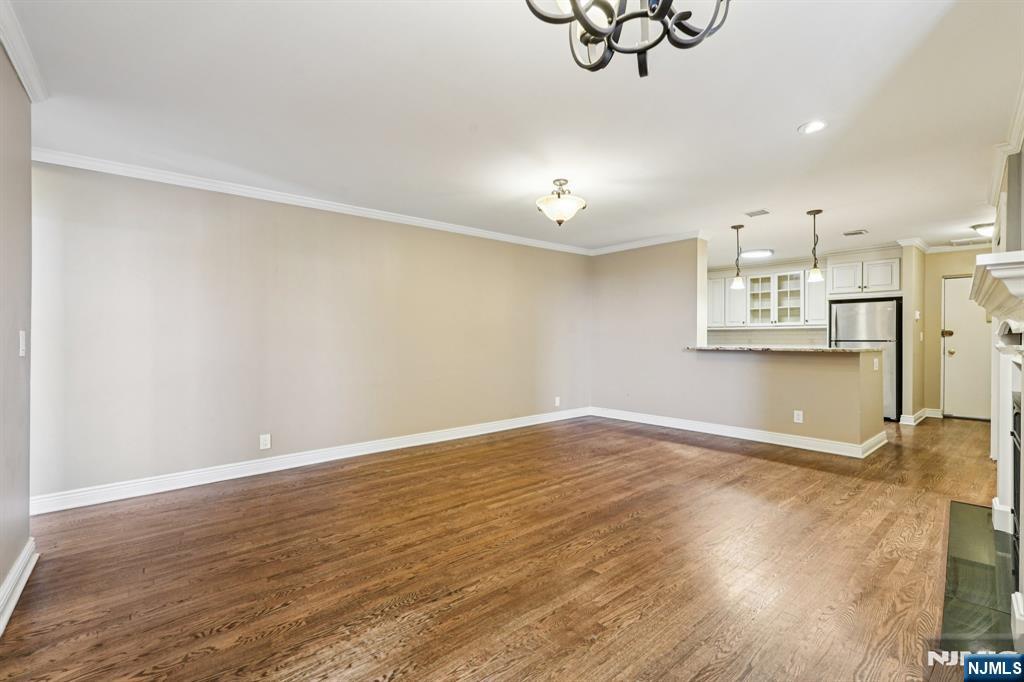 109 Grand Avenue, Unit 4A Englewood, NJ 07631 - Photo 7 of 39 a view of an empty room with wooden floor and a window