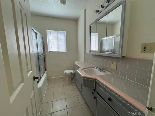 a bathroom with a double vanity sink a mirror and a bathtub