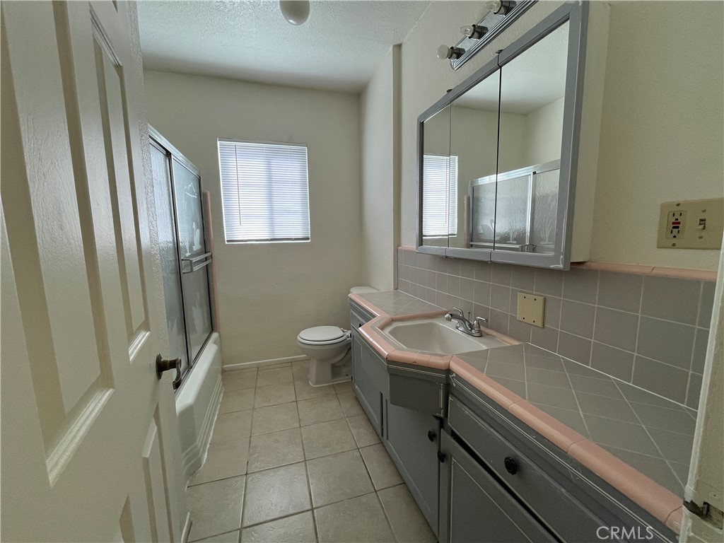 12014 Oasis Road Pinon Hills, CA 92372 - Photo 11 of 16 a bathroom with a double vanity sink a mirror and a bathtub