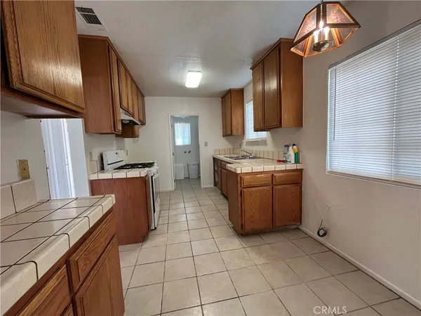 a kitchen with stainless steel appliances granite countertop a sink counter space cabinets and a stove