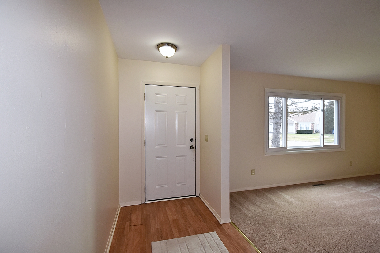 103 Tealwood Road Montgomery, IL 60538 - Photo 2 of 23 an empty room with wooden floor and windows