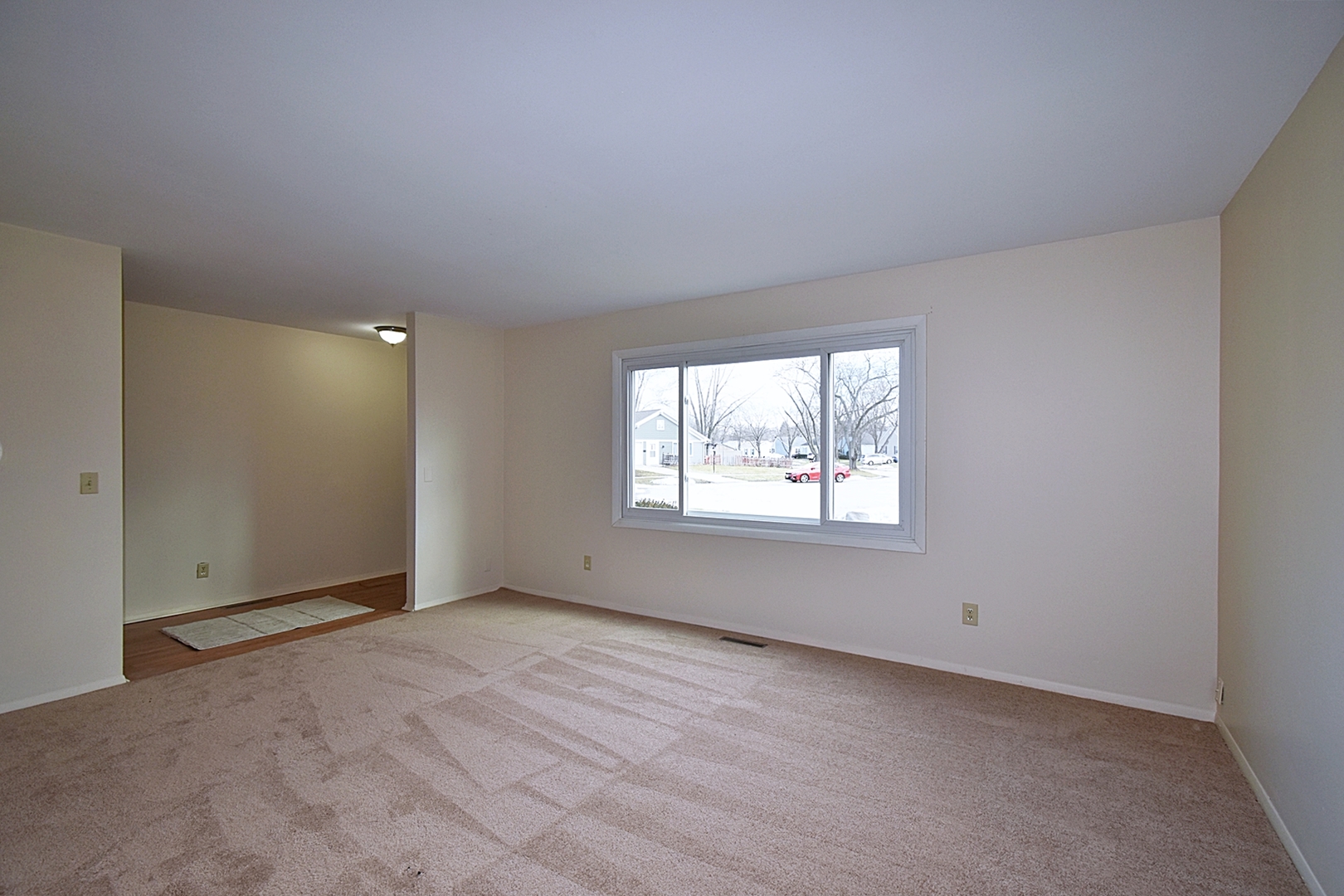 103 Tealwood Road Montgomery, IL 60538 - Photo 4 of 23 a view of an empty room with a window