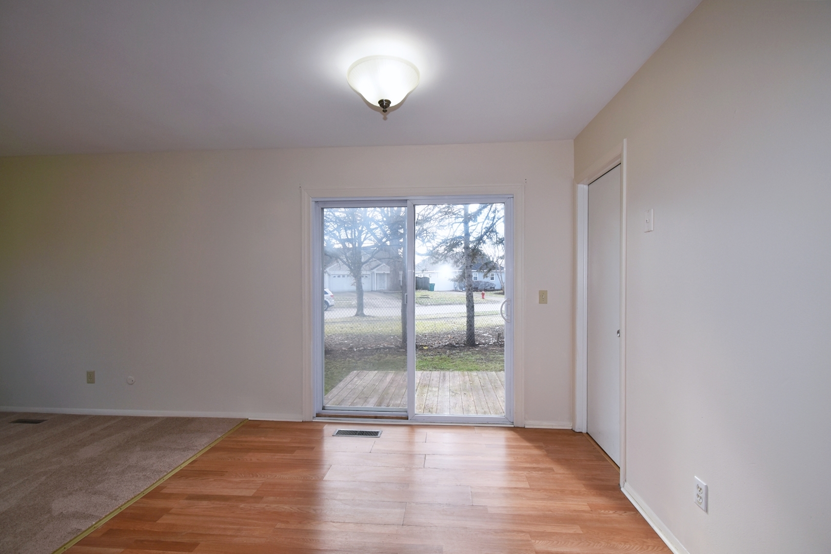 103 Tealwood Road Montgomery, IL 60538 - Photo 6 of 23 wooden floor in an empty room with a window