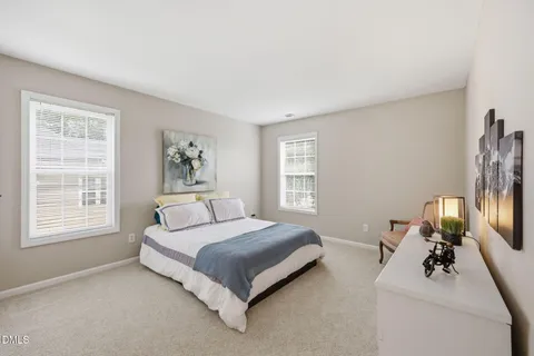 a bedroom with a bed a couch and a window