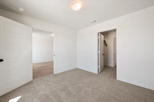 an empty room with closet area