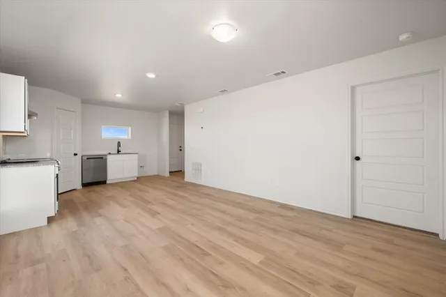 a view of a kitchen with a sink and a refrigerator