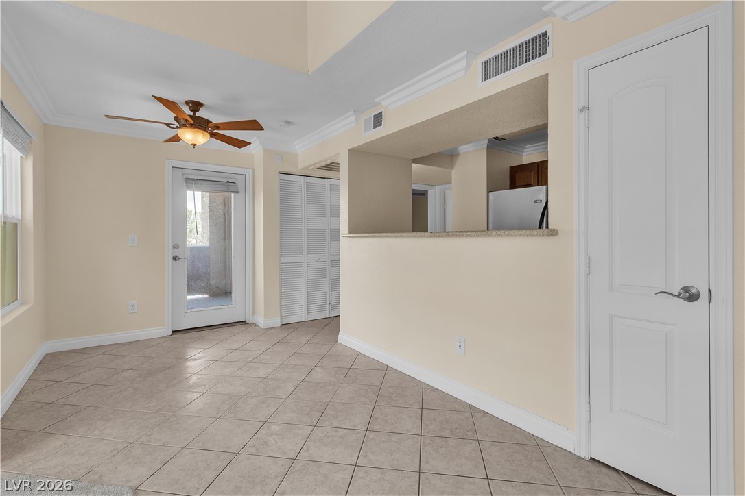 8101 West Flamingo Road, Unit 2001 Las Vegas, NV 89147 - Photo 13 of 28 A living space offers a blend of relaxation and practicality, with an adjoining kitchen space.