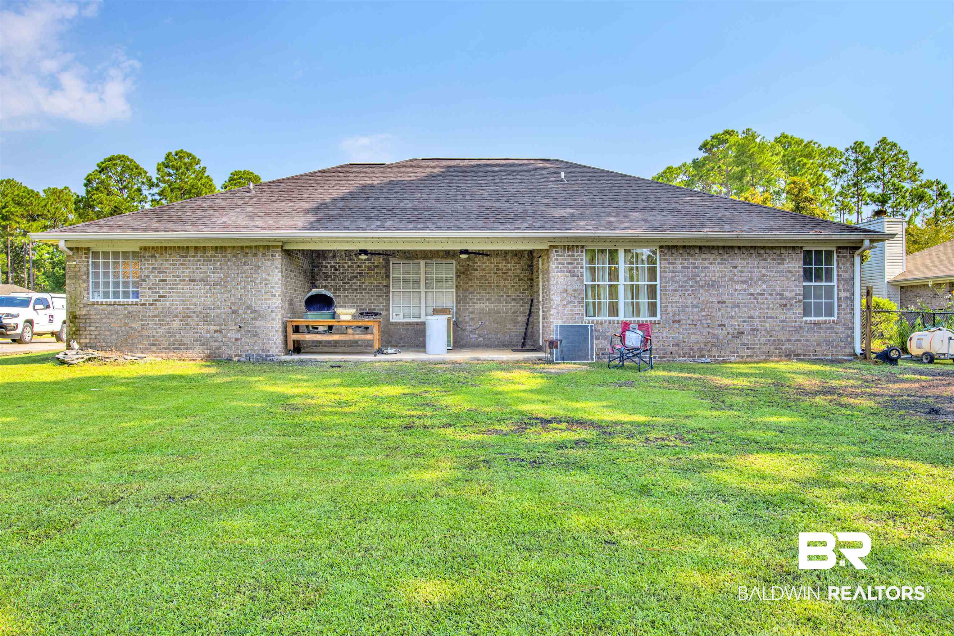 24384 Sailfish Lane Orange Beach, AL 36561 - Photo 17 of 23 Back of property with a lawn and cooling unit