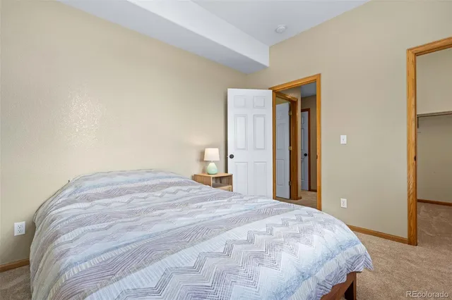 a bedroom with a bed and a mirror