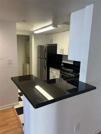 a kitchen with a sink and a stove