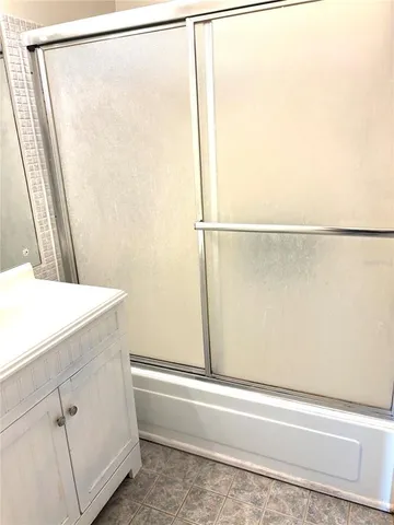 a bathroom with a shower and a sink