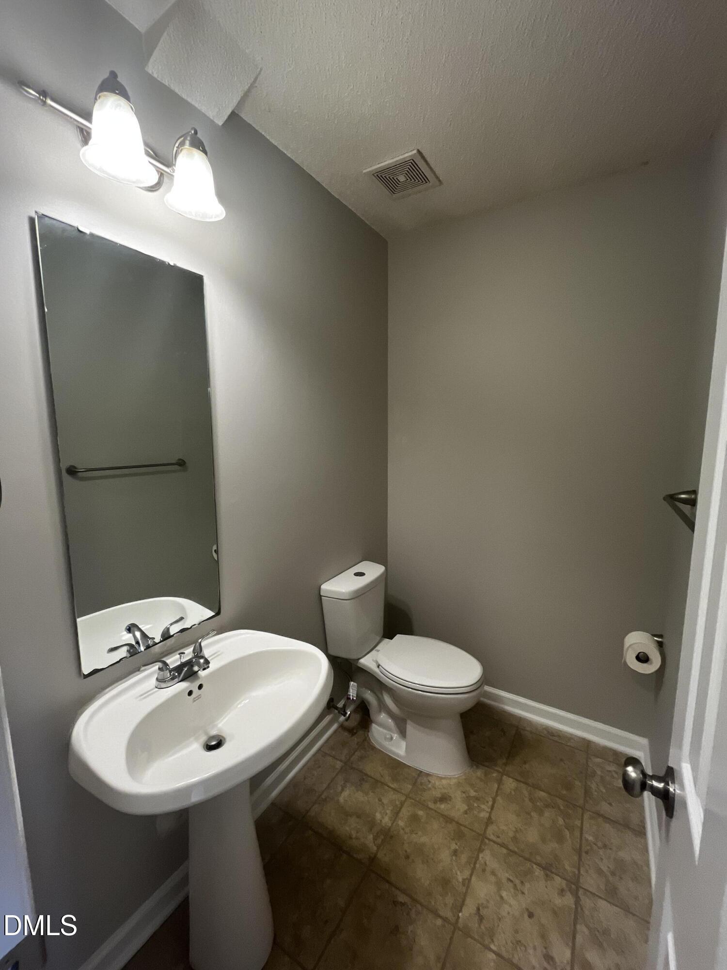 5500 Marthonna Way Raleigh, NC 27616 - Photo 14 of 19 a bathroom with a sink toilet and a mirror
