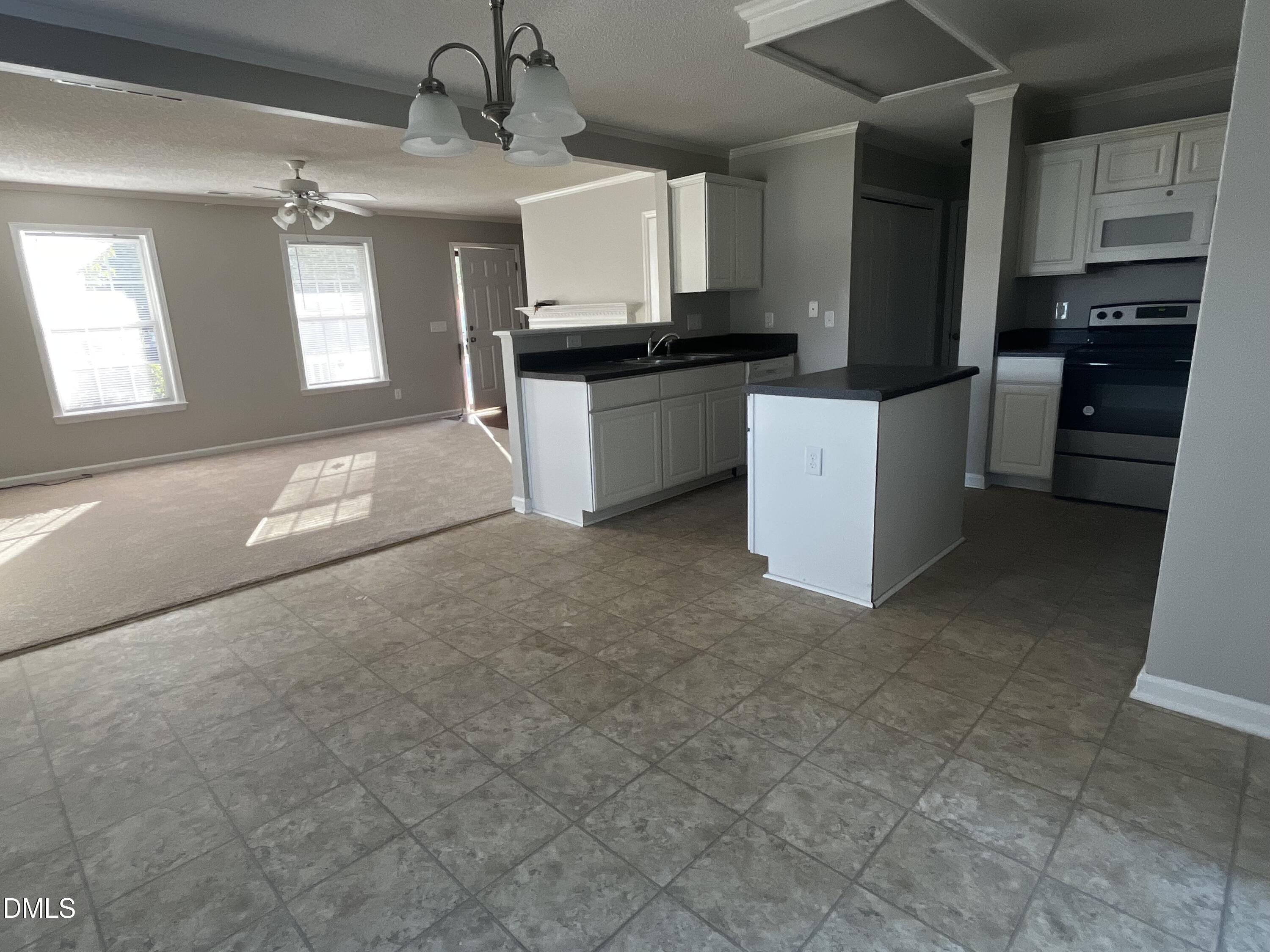 5500 Marthonna Way Raleigh, NC 27616 - Photo 18 of 19 a kitchen with a refrigerator a stove top oven a sink and dishwasher