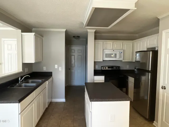 a kitchen that has a sink and a stove in it