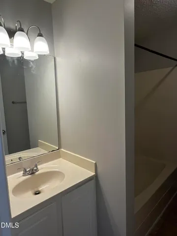 a bathroom with a sink and mirror