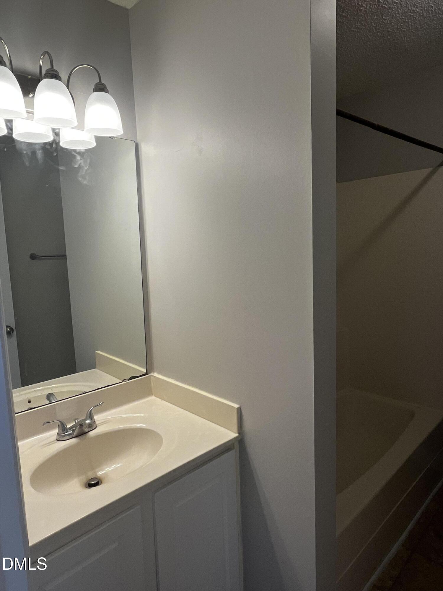 5500 Marthonna Way Raleigh, NC 27616 - Photo 6 of 19 a bathroom with a sink and mirror