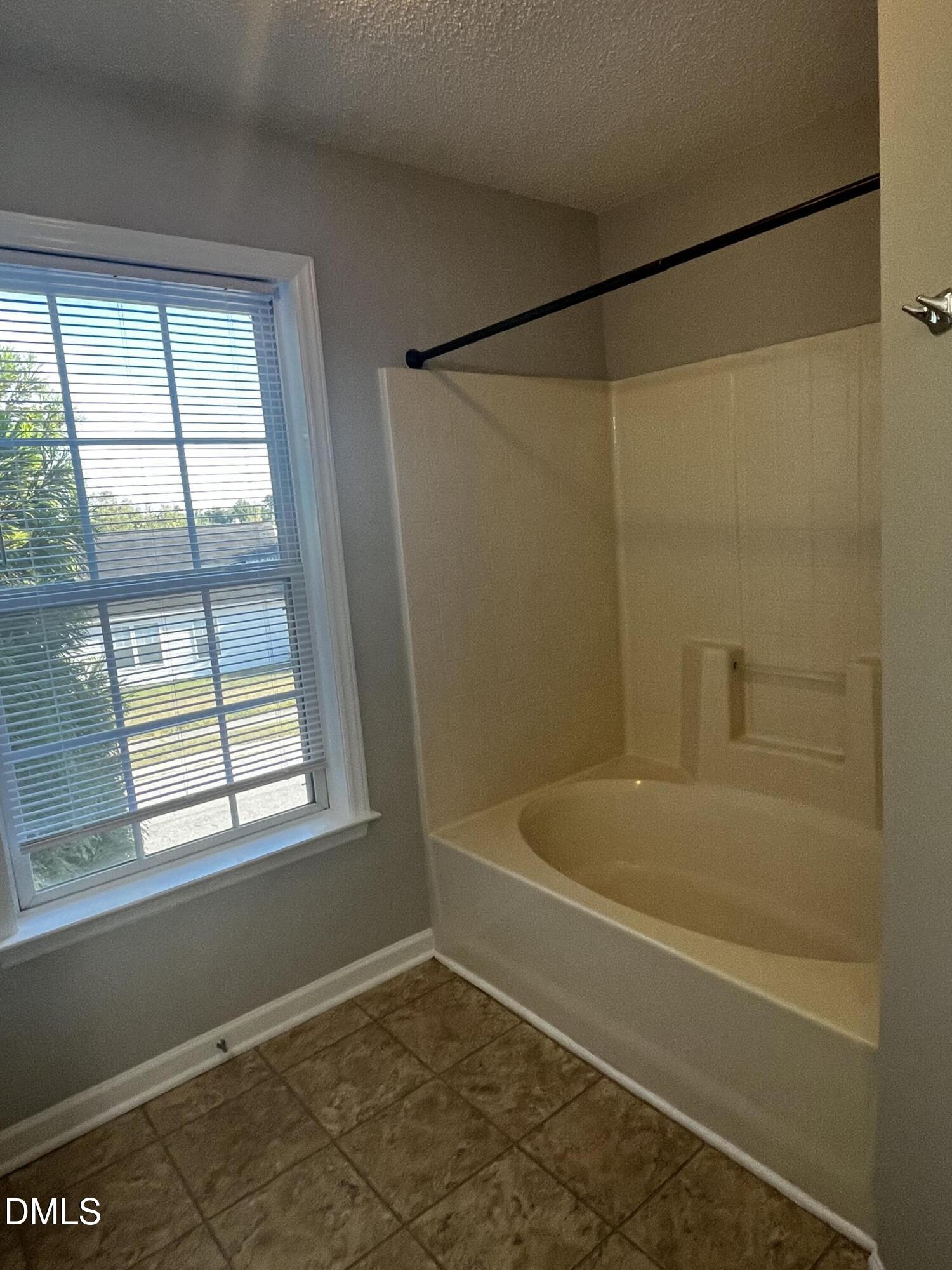 5500 Marthonna Way Raleigh, NC 27616 - Photo 8 of 19 a bathroom with a bath tub and a shower