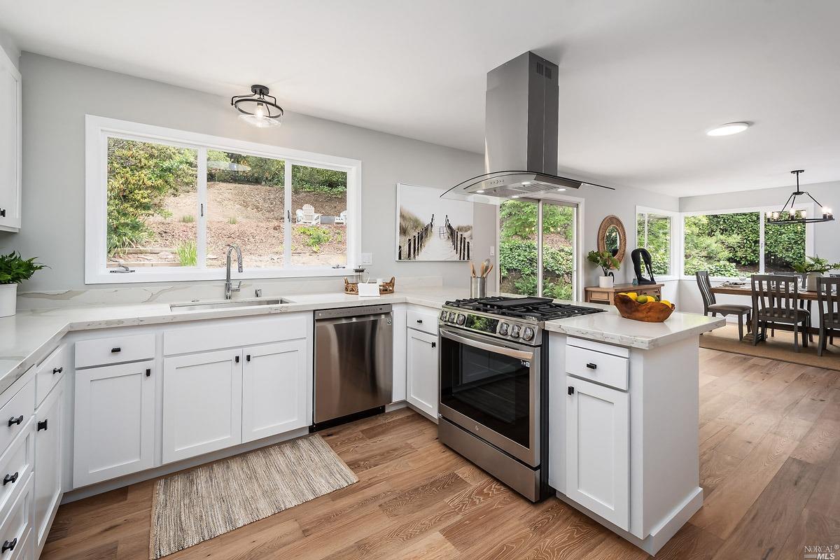 a kitchen with stainless steel appliances a stove sink and cabinets