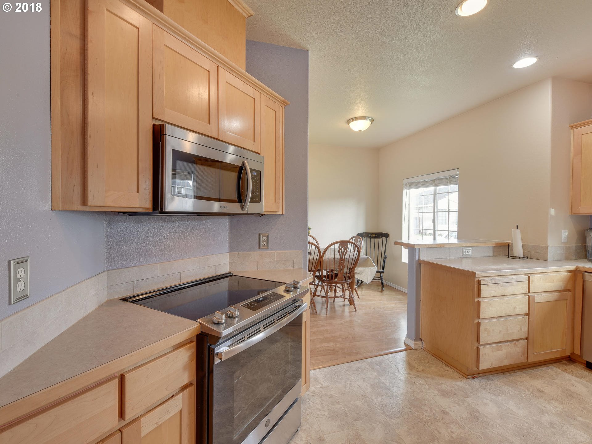 34484 Vail Court St. Helens, OR 97051 - Photo 4 of 16 a kitchen with a stove cabinets and microwave