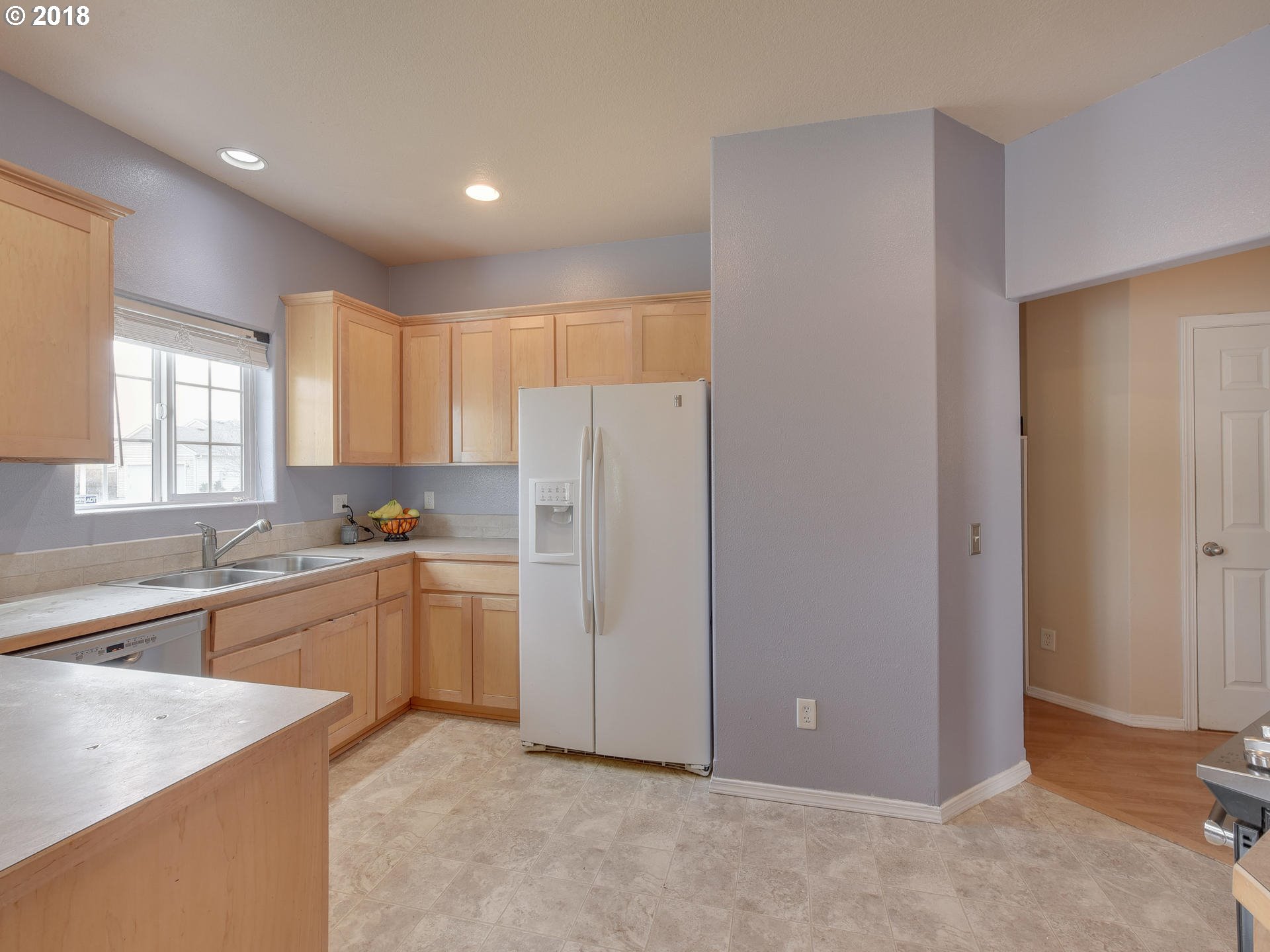 34484 Vail Court St. Helens, OR 97051 - Photo 5 of 16 a large kitchen with a refrigerator a sink dishwasher with a dining table and chairs