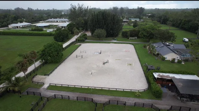 an aerial view of a house with pool outdoor seating and yard
