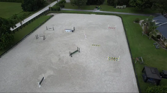 a view of a swimming pool and a yard in back