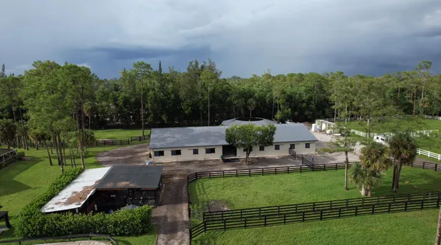 an aerial view of a house with garden space and street view