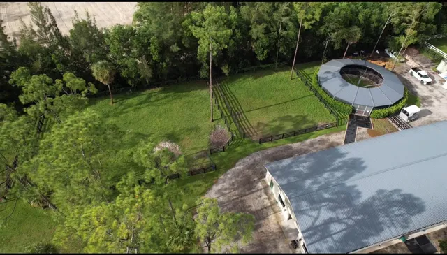 a view of a backyard with a table and chairs