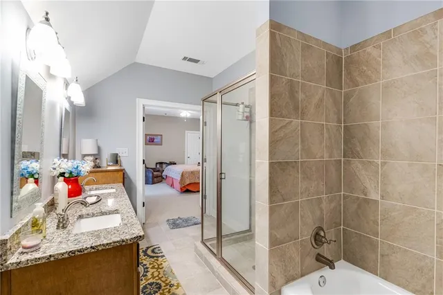 a bedroom with two beds and a chandelier