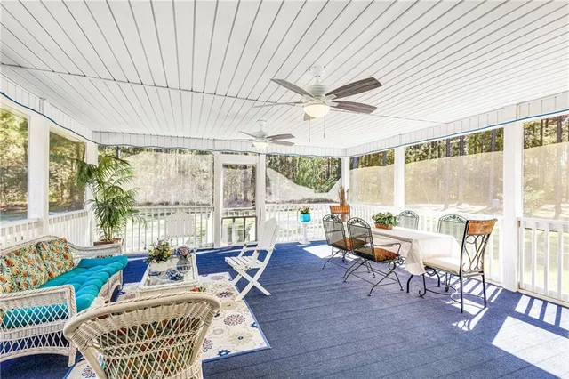 a large kitchen with kitchen island a large window cabinets and stainless steel appliances