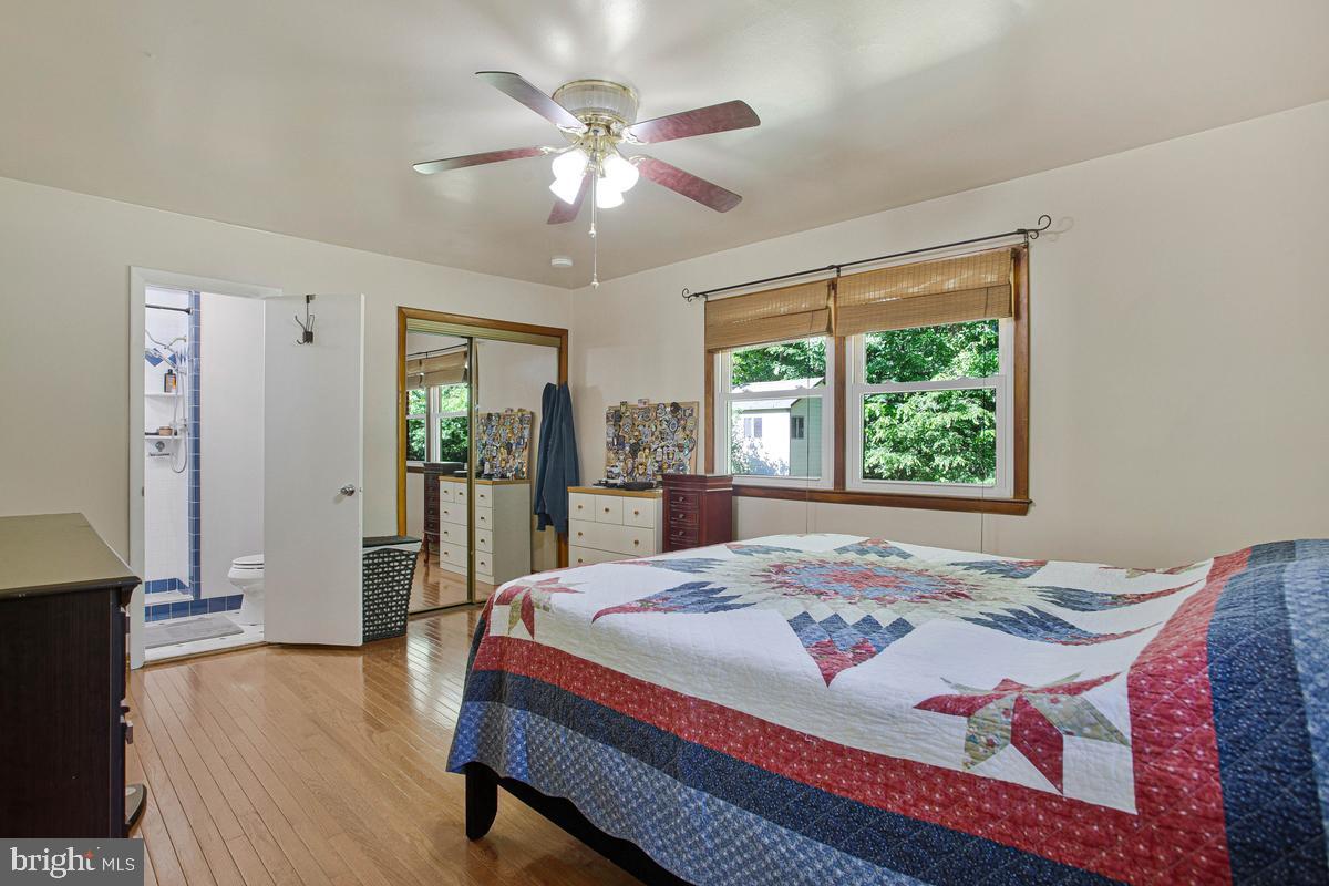 6600 Ashland Road La Plata, MD 20646 - Photo 22 of 40 a bedroom with a large bed and a chandelier