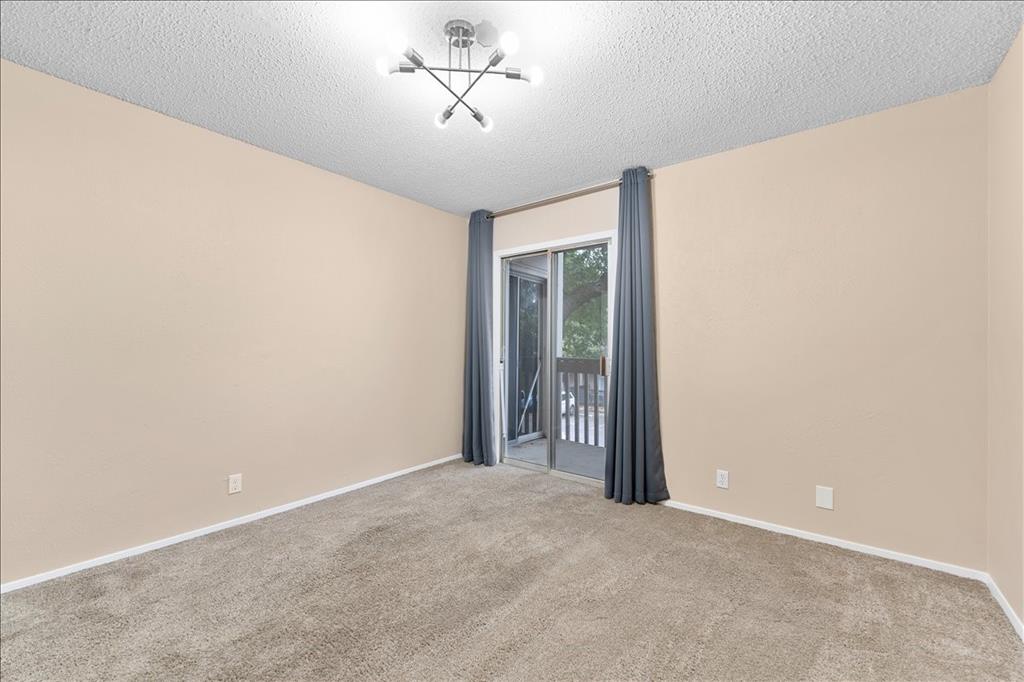 4859 Cedar Springs Road, Unit 241 Dallas, TX 75219 - Photo 18 of 38 a view of a livingroom with a chandelier fan