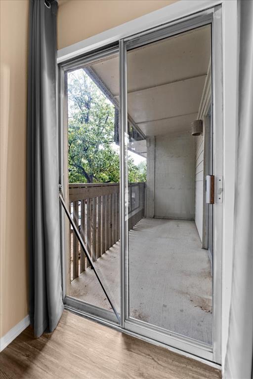 4859 Cedar Springs Road, Unit 241 Dallas, TX 75219 - Photo 19 of 38 a view of a room with wooden floor and windows