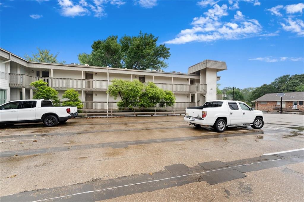 4859 Cedar Springs Road, Unit 241 Dallas, TX 75219 - Photo 2 of 38 a view of a cars park in front of a house