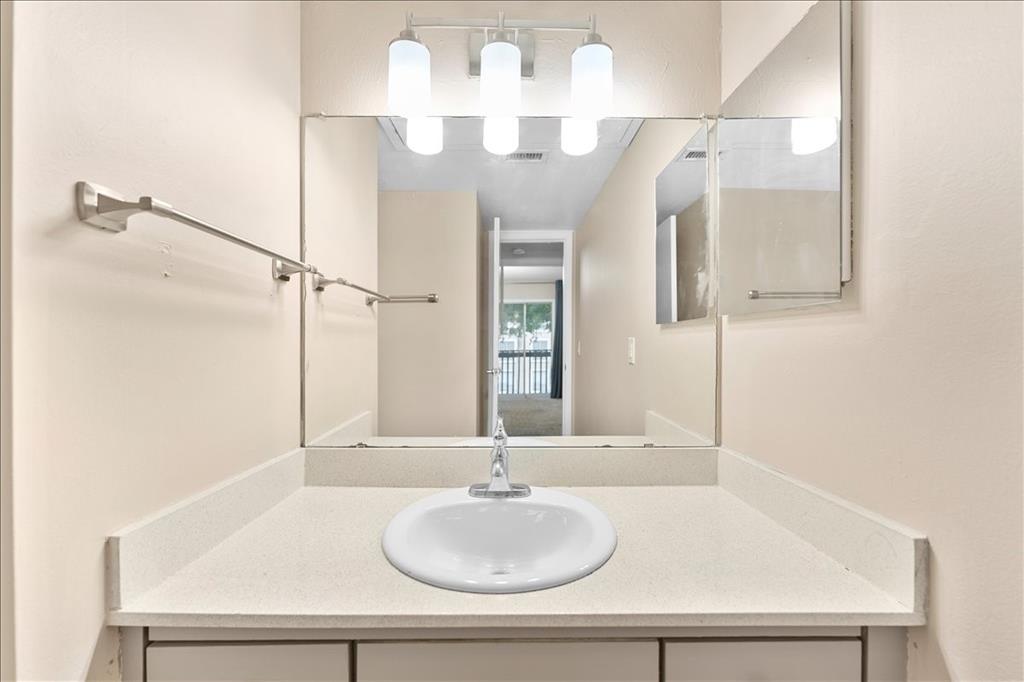 4859 Cedar Springs Road, Unit 241 Dallas, TX 75219 - Photo 22 of 38 a bathroom with a sink and a mirror