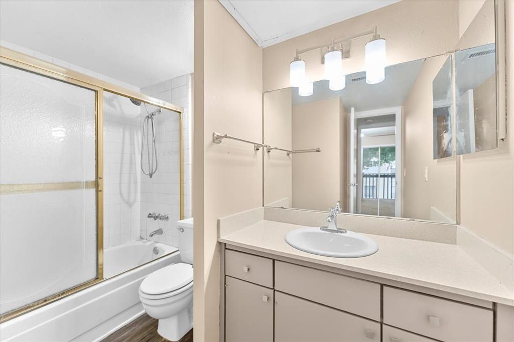 4859 Cedar Springs Road, Unit 241 Dallas, TX 75219 - Photo 23 of 38 a bathroom with a sink a toilet and shower