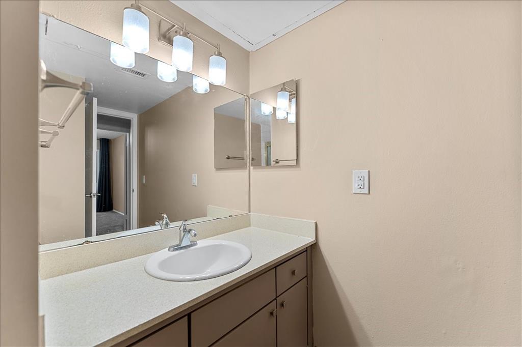 4859 Cedar Springs Road, Unit 241 Dallas, TX 75219 - Photo 24 of 38 a bathroom with a sink and a mirror