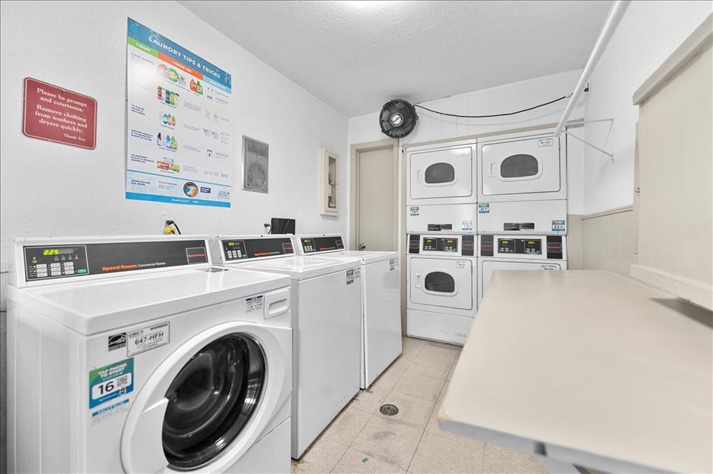 4859 Cedar Springs Road, Unit 241 Dallas, TX 75219 - Photo 33 of 38 a view of washer and dryer with a kitchen view