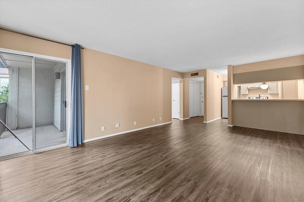 4859 Cedar Springs Road, Unit 241 Dallas, TX 75219 - Photo 7 of 38 an empty room with wooden floor and windows