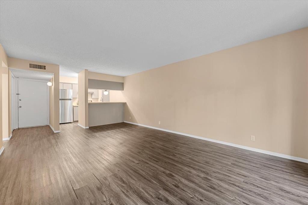 4859 Cedar Springs Road, Unit 241 Dallas, TX 75219 - Photo 8 of 38 a view of empty room with wooden floor and fireplace