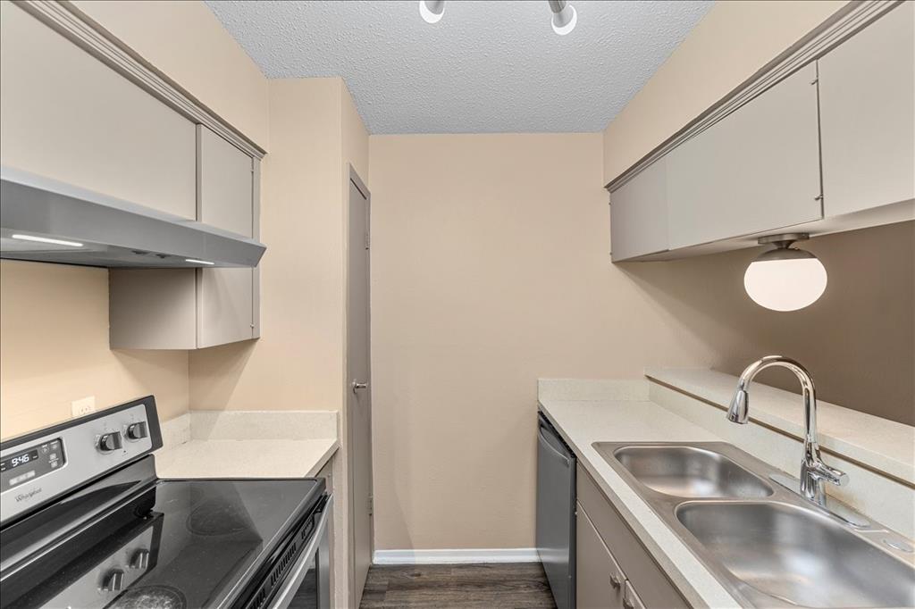 4859 Cedar Springs Road, Unit 241 Dallas, TX 75219 - Photo 10 of 38 a kitchen with stainless steel appliances granite countertop a sink and a stove