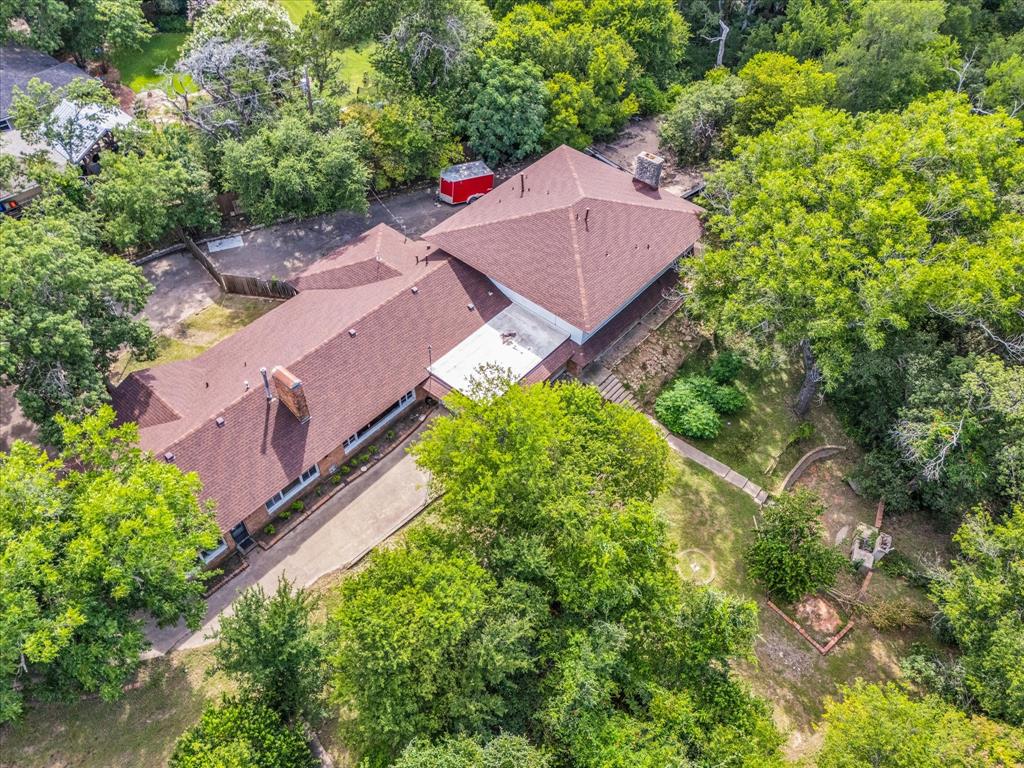 421 Rice Avenue Waco, TX 76708 - Photo 13 of 22 Expansive property featuring a multi-gabled roofline, mature trees, and a concrete driveway