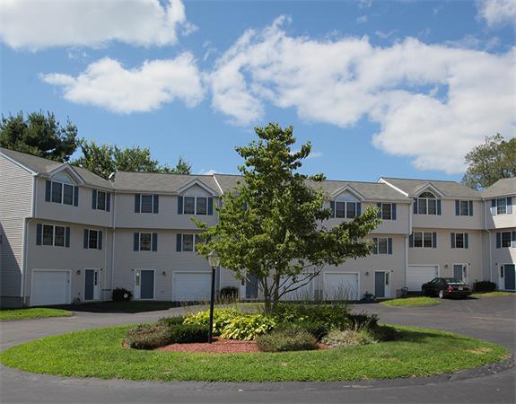 985 Trapelo Road, Unit 5 Waltham, MA 02452 - Photo 2 of 15 a view of a big yard in front of a brick house
