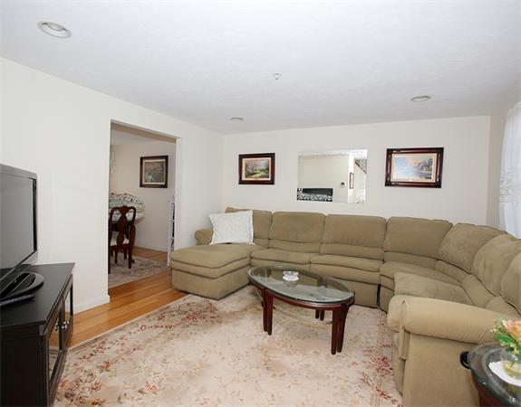 985 Trapelo Road, Unit 5 Waltham, MA 02452 - Photo 4 of 15 a living room with furniture a couch and a flat screen tv