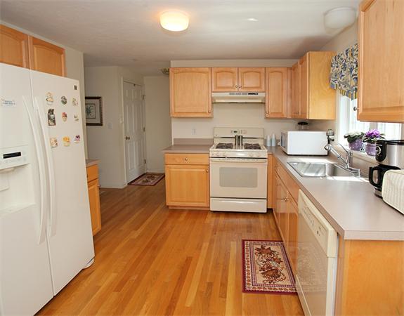 985 Trapelo Road, Unit 5 Waltham, MA 02452 - Photo 8 of 15 a kitchen with a sink a refrigerator a stove top oven a washer and dryer