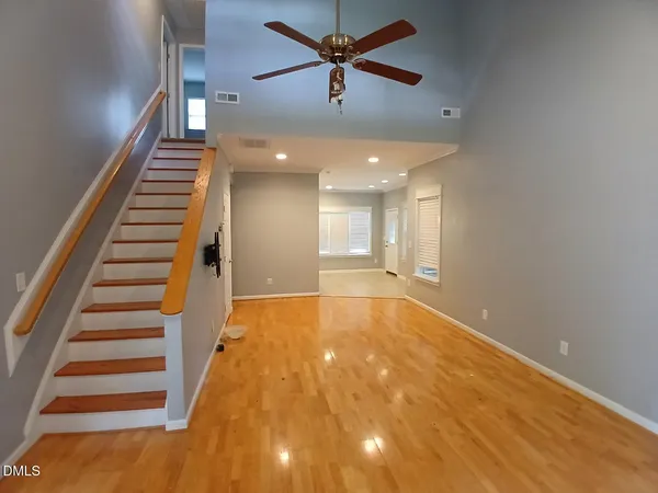 a view of an empty room with wooden floor
