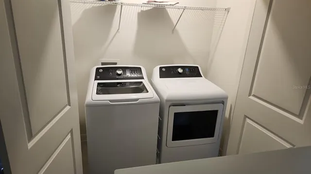 a utility room with dryer and washer